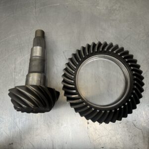 The Import placeholder for 1648, featuring a metal pinion gear shaft and a matching helical ring gear, is displayed side by side on a scratched metallic surface.