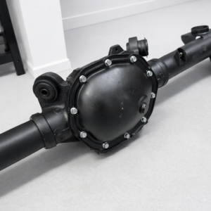 A Holden HQ Rebuilt Rear Diff 3.36 Ratio LSD, black in colour, sits on a light grey floor, featuring visible bolts around the cover and axle tubes extending from both sides.