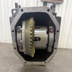 A close-up of a Mazda Rx7 FD 4.3 Cusco 1.5 way rebuilt rear diff shows visible gears and bolts, placed upright on a metal surface against a light, vertically-striped background.