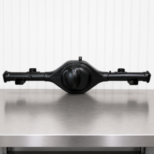 A Holden HQ-WB UTE Ford 9" Diff Housing 40mm Narrow rests centred on a stainless steel workbench, set against a white vertical panel backdrop.