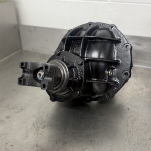 A Brand New Ford 9 Inch LSD Diff Head rests on a stainless steel workbench, with a white tiled wall in the background.