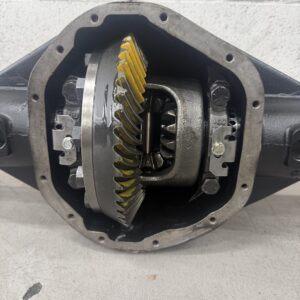 Close-up view of an open Nissan Navara D40 Rebuilt Exchange Diff (3.69 ratio) showing internal gears with yellow marking compound on the ring gear teeth, set against a light-coloured wall background.