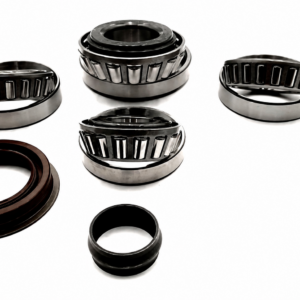 Six metal bearings from the Holden Colorado RG Rear Diff Bearing Kit and one brown circular seal are arranged on a white background; some bearings are standing whilst others are lying flat.