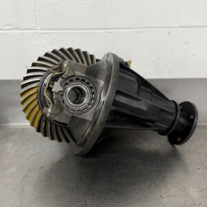 A Nissan Safari / Patrol H233B 4.11 Rebuilt Front Exchange Diff rests on a metal surface with a white brick wall in the background.